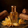 Attar Champa fragrance bottle with yellow champa flowers and sandalwood, showcasing traditional Indian scents.