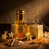 Attar Molshri fragrance bottle with sandalwood, flowers, and resin on wooden surface highlighting its natural essence.