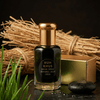 Ruh Khus vetiver fragrance bottle with golden cap and packaging on a dark surface.